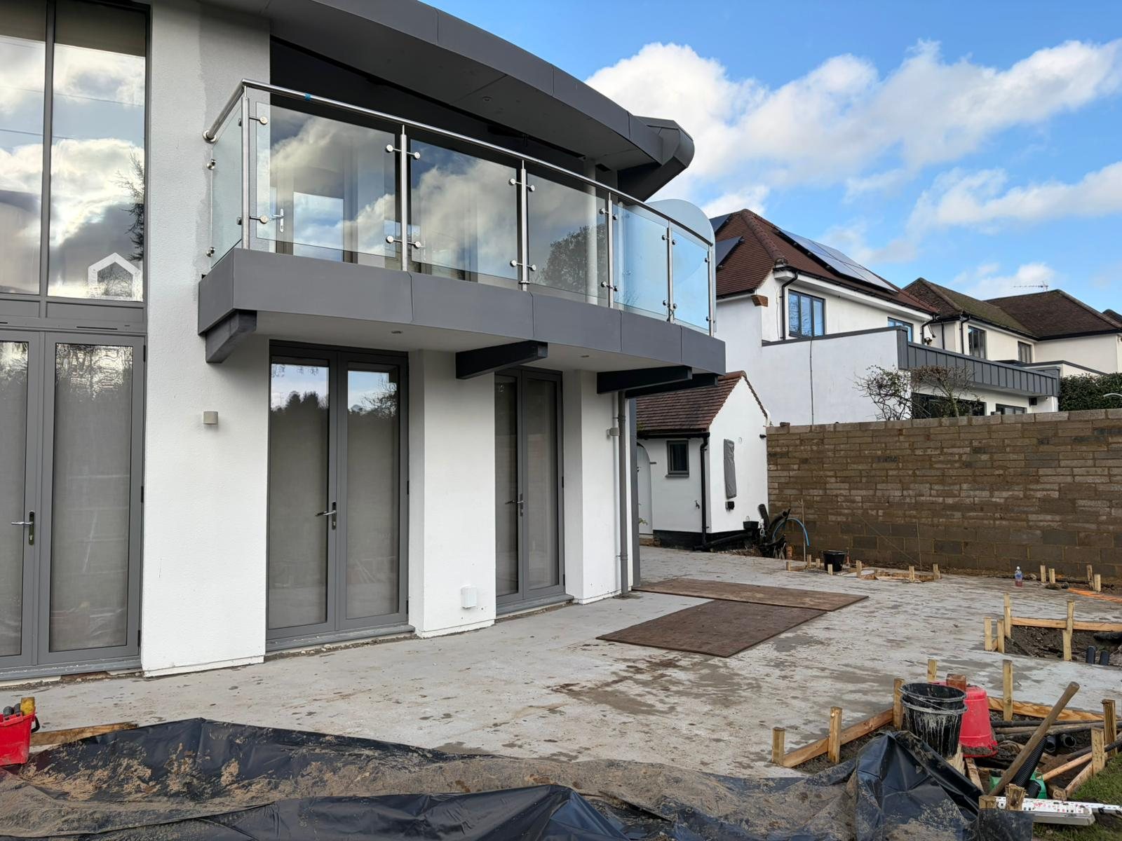 Curved balcony fascias. Formed fascias and soffits to a curved glass balustrade