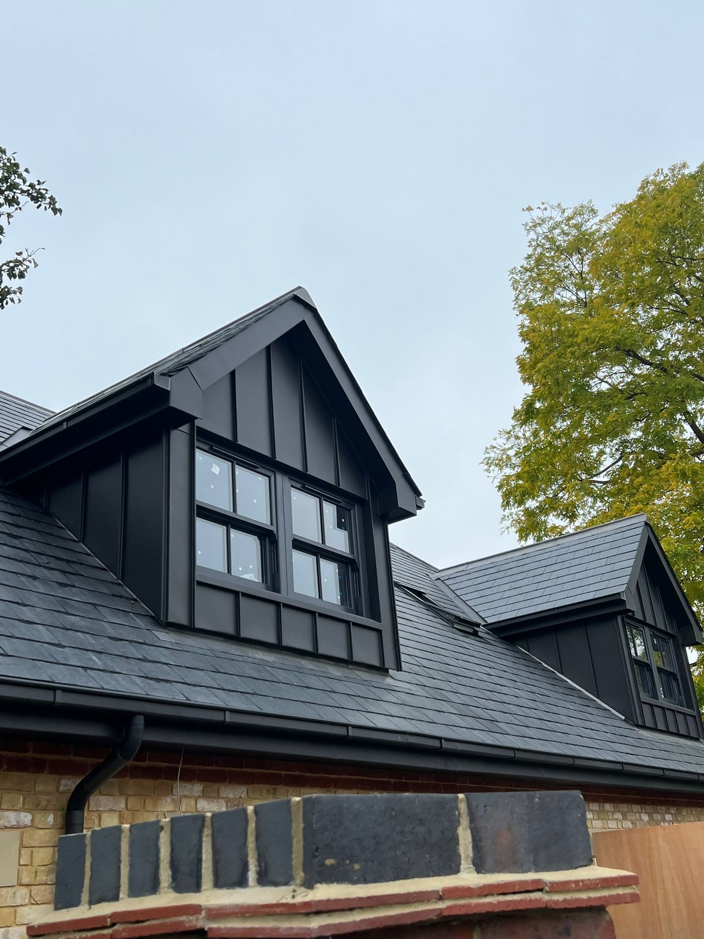 Mock Tudor dormer set. Black zinc dormer cheeks and roofs on a mock Tudor elevation